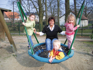 Manuela Cotterrell mit 3 Kindern auf einer großen Schaukel